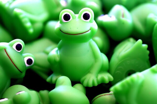 A bunch of green rubber toys