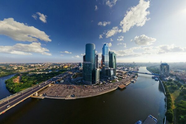 Photo of Moscow city against the background of blue sky and river