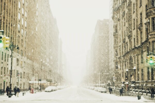 Winter street in a megalopolis with a traffic light