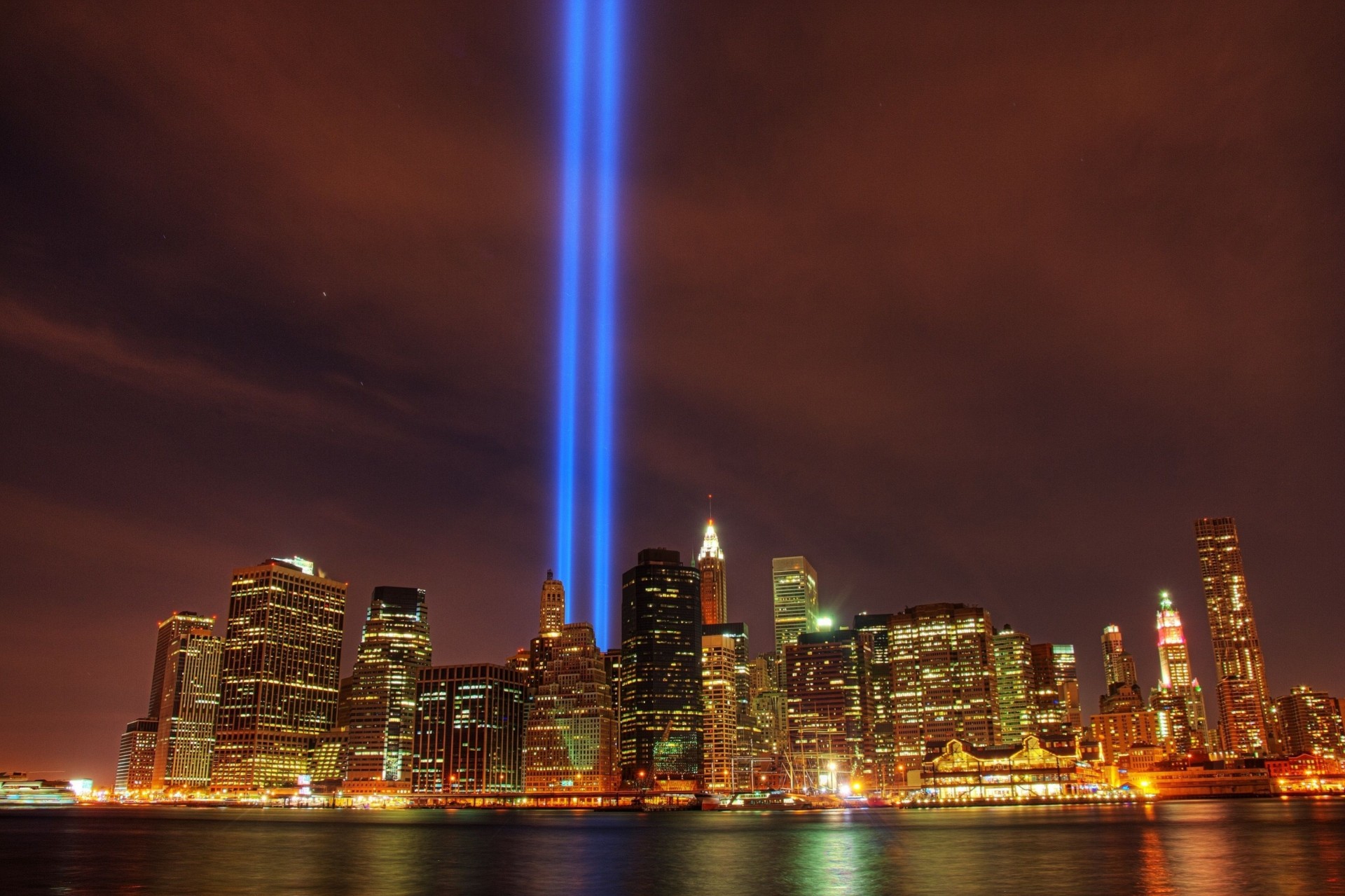 memory searchlights night river new york skyscraper metropolis town light building manhattan united state