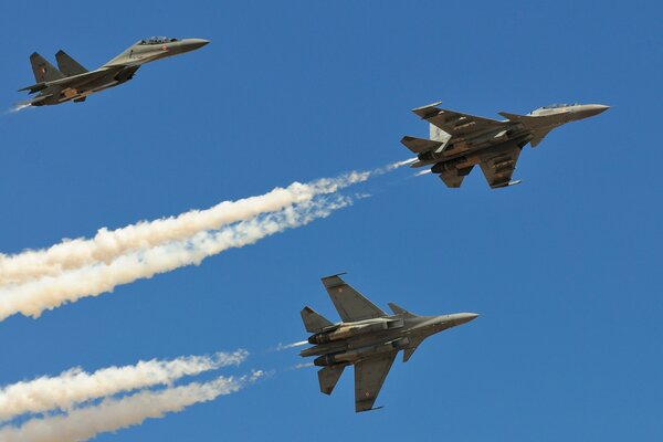 Soviet fighter jets fly across the clear blue sky