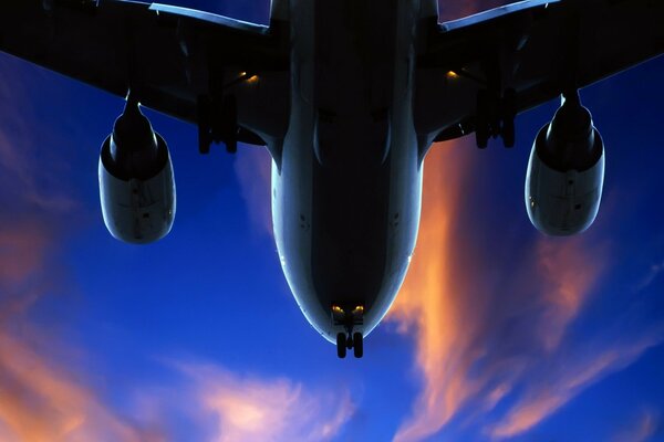 The plane lands in the evening twilight