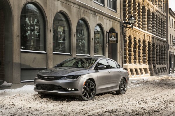 Chrysler 200c parked near the building in winter