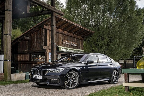 Black BMW next to the shop