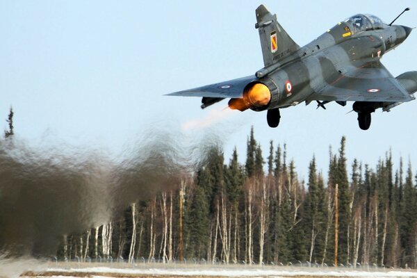 A military plane takes off into the sky