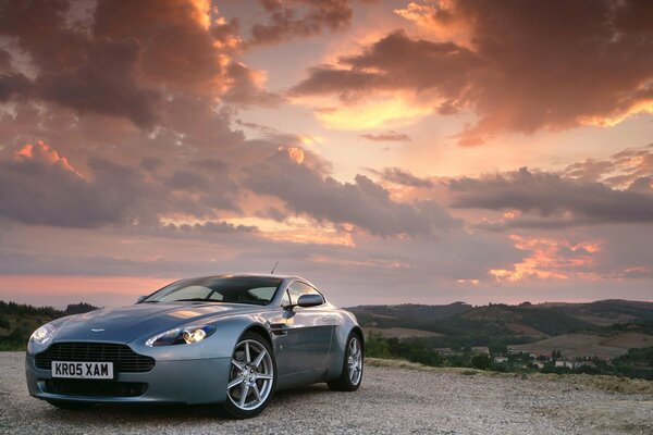 Expensive car on the background of mountains under clouds