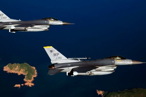 A military fighter jet is flying over the islands