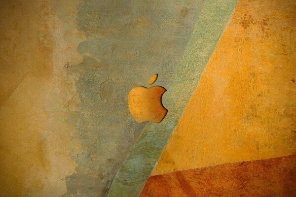 Apple logo in orange shades on the background of the wall