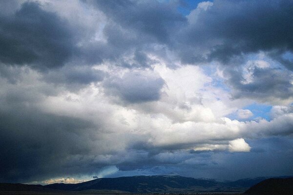 Dark clouds covered the blue sky