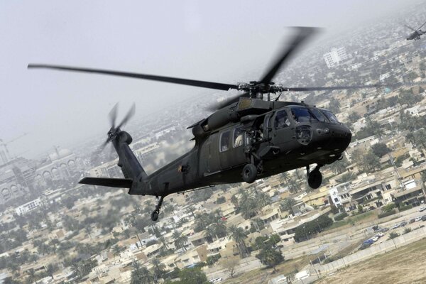 A helicopter flying over a big city