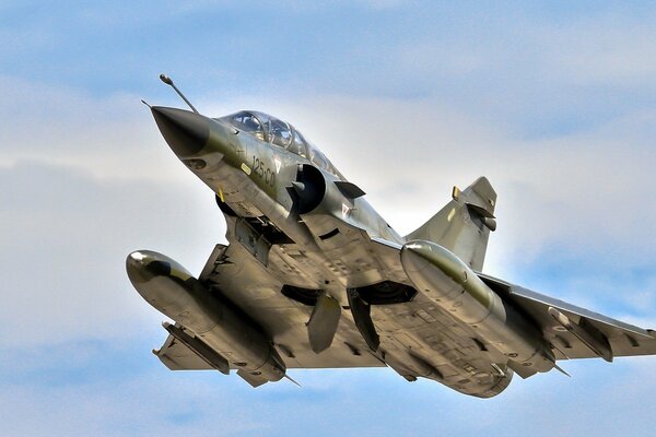 Combat aircraft on the background of a peaceful sky