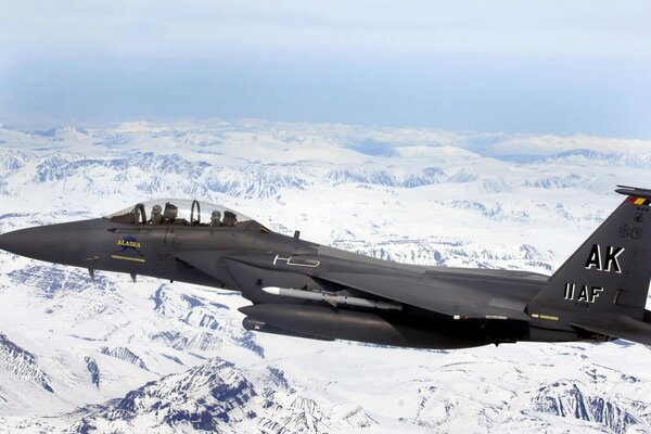 Military aircraft over snow-covered mountains