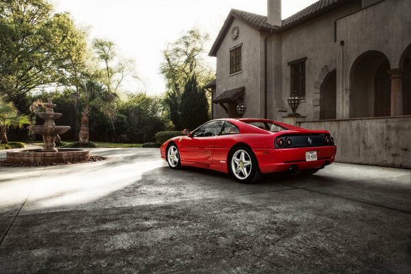 Red Ferrari at the stone mansion