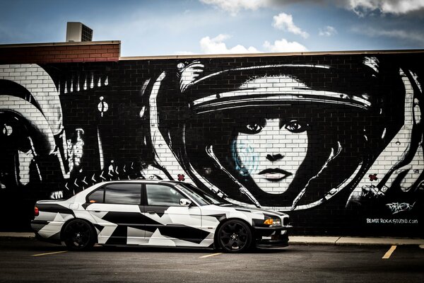 Car on the background of a wall with graffiti