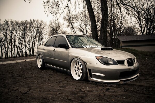 Silver Subaru impreza on the sand