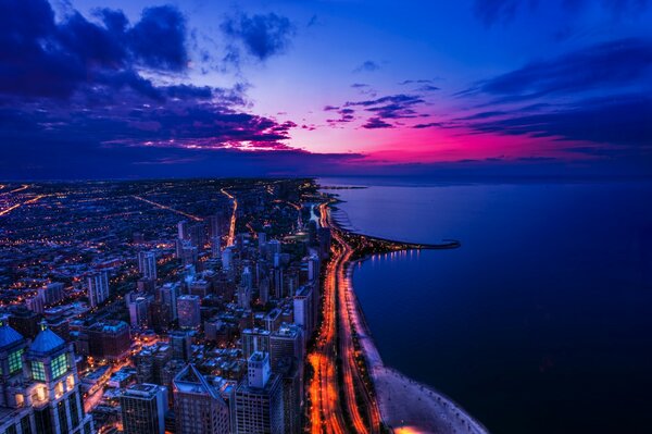 A busy city at night and a calm ocean