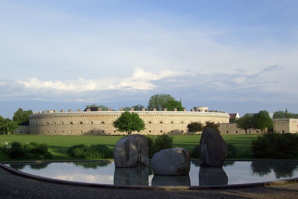 A park with a pond near the German fortress