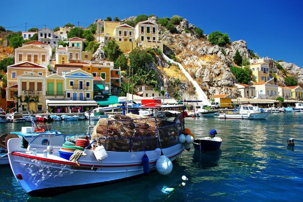 Boat with cargo on the background of a city in Greece