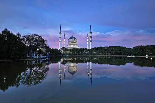 Mosque at sunset in the reflection of the lake