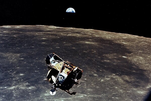 The Apollo 11 ship next to the moon on the background of the Earth