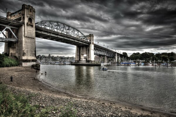 Pont sur la rivière sur fond de ciel nuageux