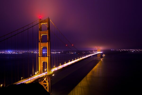 A bridge in the fog over the ocean