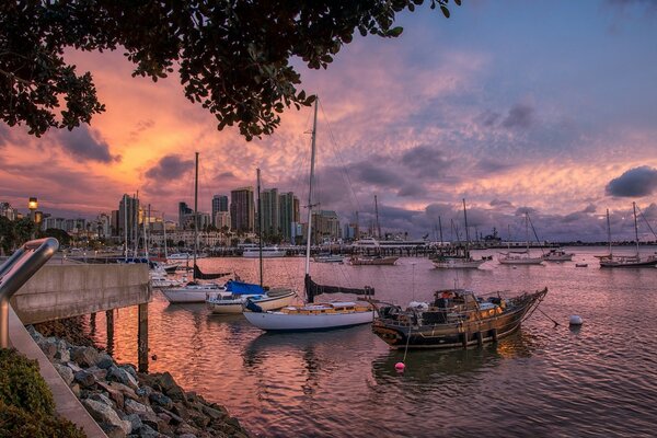 Boat pier on the background of a colorful sunset