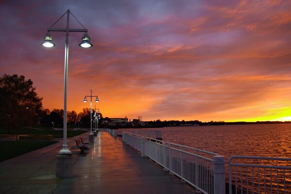 Sunset is visible from the bench on the embankment