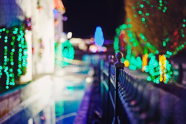 Night sidewalk with lights at the fence