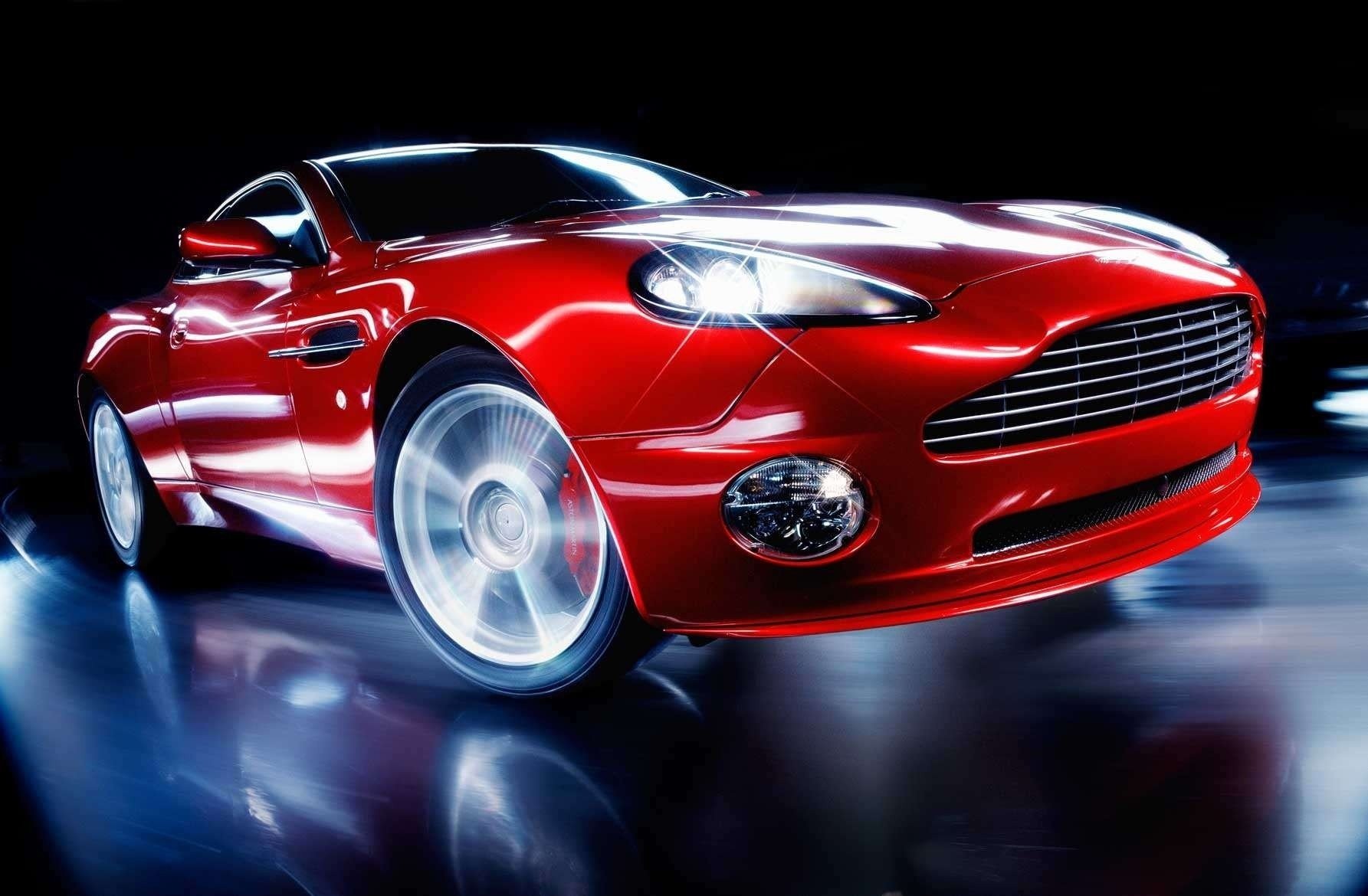 aston martin rojo brillo de las luces de los faros luz de los faros viraje velocidad desenfoque brillo lujo auto coche rojo coche fresco coche deportivo transporte vehículos de motor forma estilo diseño exposición resplandor aston martin