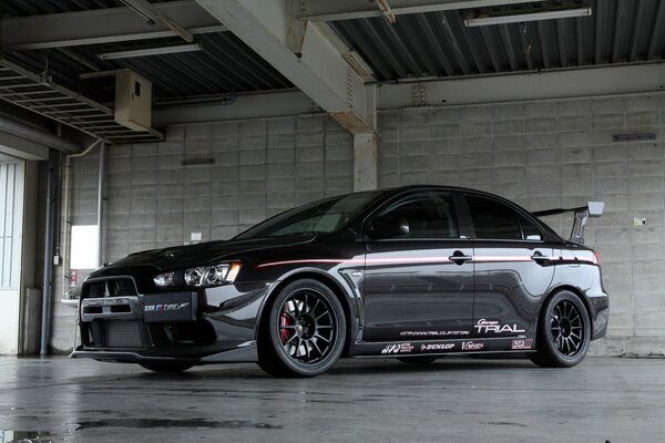 Black mitsubishi lancer indoors