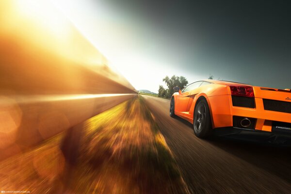 An orange car rushes down the road