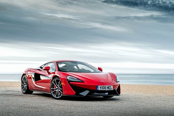 Beautiful red car on the sky background