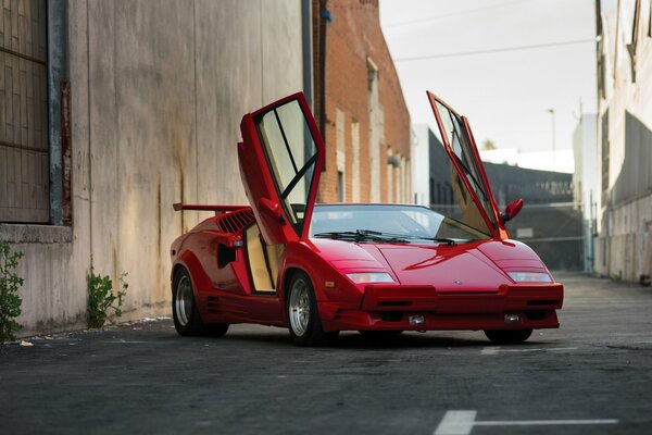 Czerwony Lamborghini Countach z podniesionymi drzwiami, przedni kąt, lokalizacja na zewnątrz