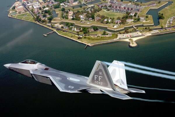 A fighter plane flies over the city