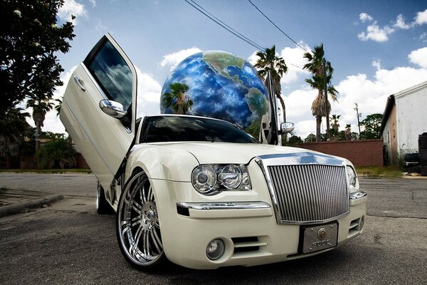 Beige Chrysler with a large globe