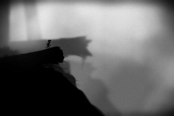 Little boy on a cliff, black and white background