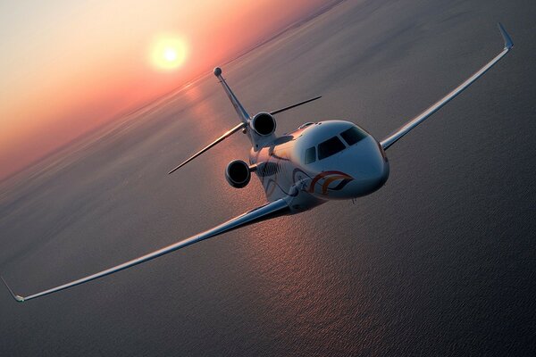 A liner flying by the sea at sunrise