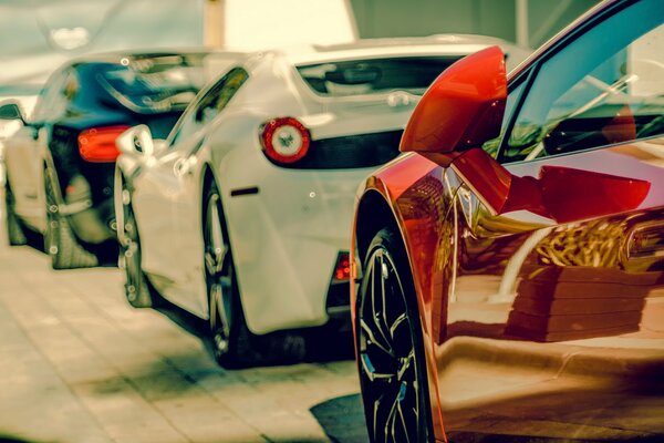 Black, white and red cars are in a row