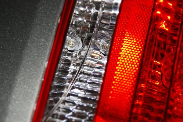 Macro photo of car headlights. A burning light bulb in the handicap