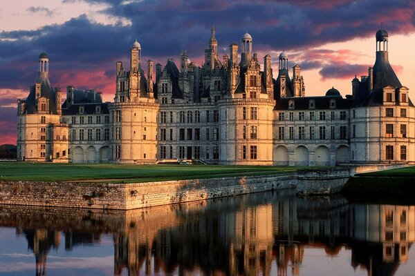 The ancient castle is reflected in the water