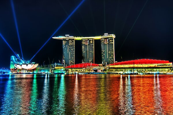 Rainbow reflection on the water of casino lights in Singapore