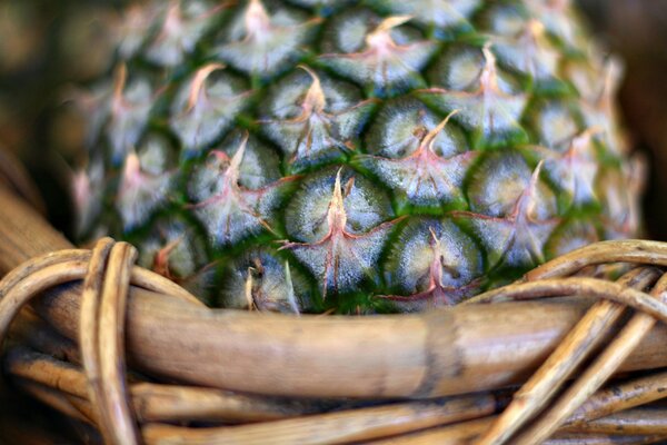 Macro photography of pineapple in a willow basket