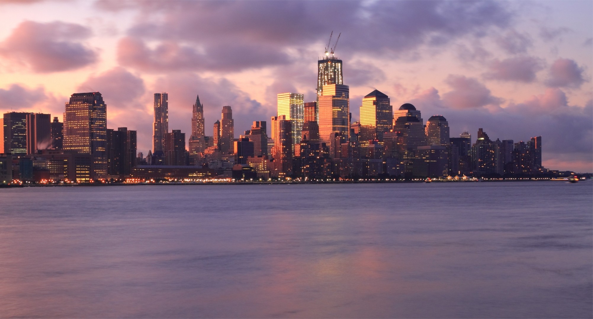 lights clouds skyscraper river sunset new york light metropolis night sky building pink united state