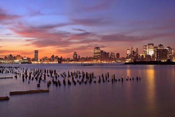 Skyscrapers in the distance against an orange sunset in America