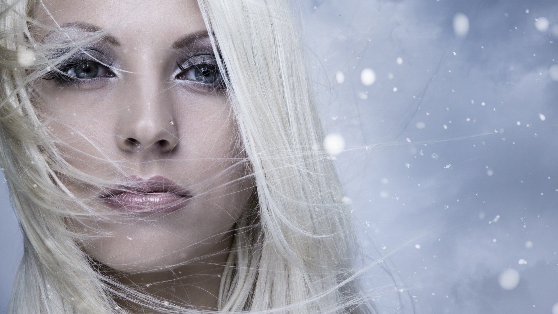 a woman snow girl grey close up winter blonde face