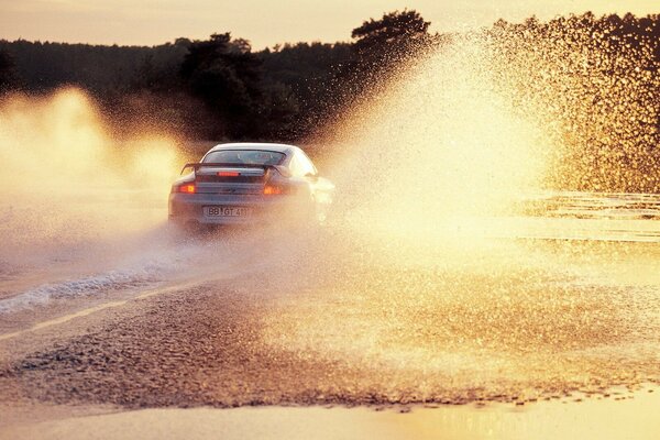 Splashes from a puddle at sunset look very advantageous