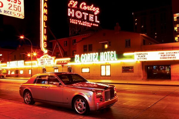 A car in a night city under neon lighting