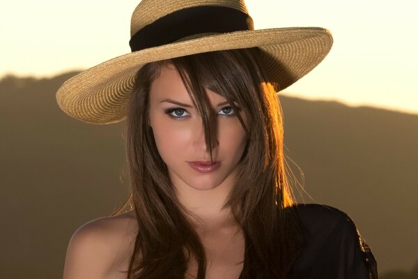 A girl in a hat with pigeon eyes and dark hair