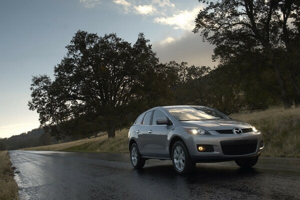 Mazda on the road on a wet road